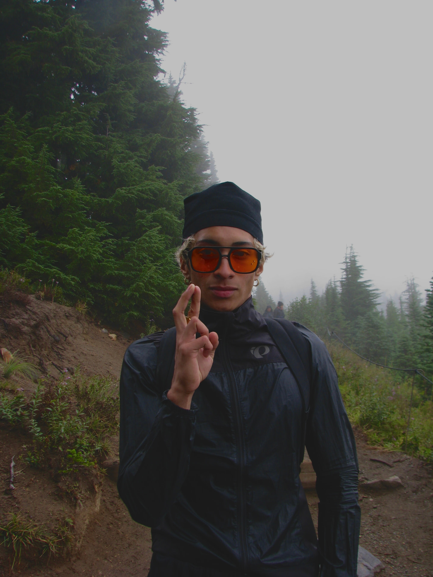 Siva Brathapan, founder of REVITALIZED, standing on a misty forest trail